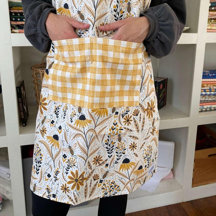 Bee Garden Apron—bake in style with gingiber apron featuring bee & floral print, adjustable neck strap, large pocket, 100% cotton canvas