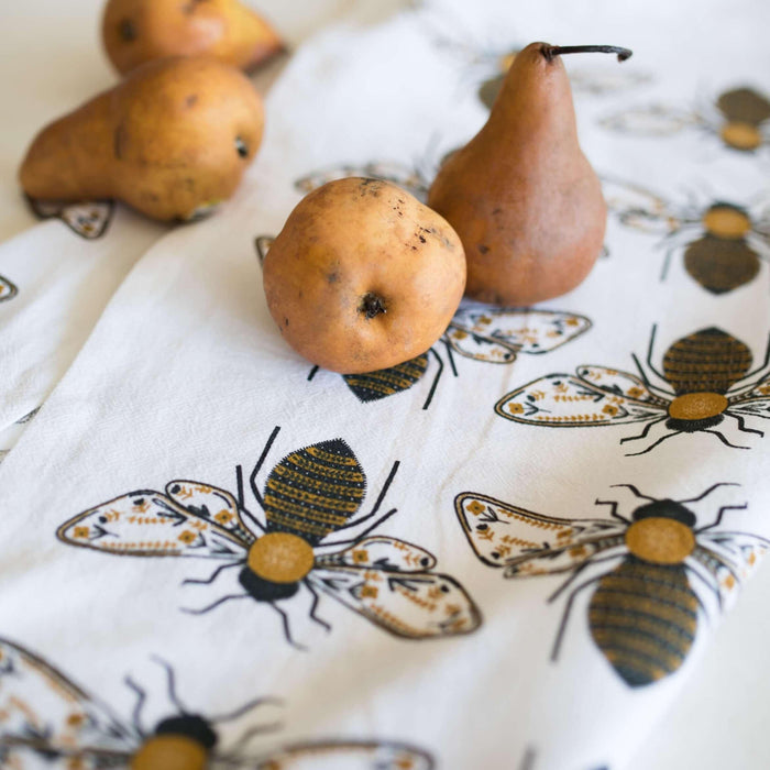 tea towel with illustrated bees and floral elements