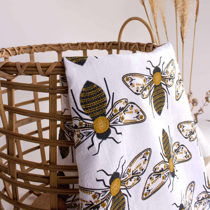 tea towel with illustrated bees and floral elements