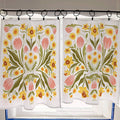 Floral patterned curtains hanging on a rod with a tiled wall background.