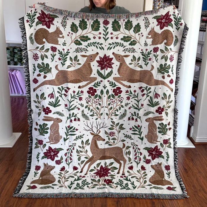 Blanket - woven throw featuring winter and forest animal illustrations on light background