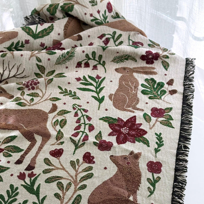 Blanket - woven throw featuring winter and forest animal illustrations on light background