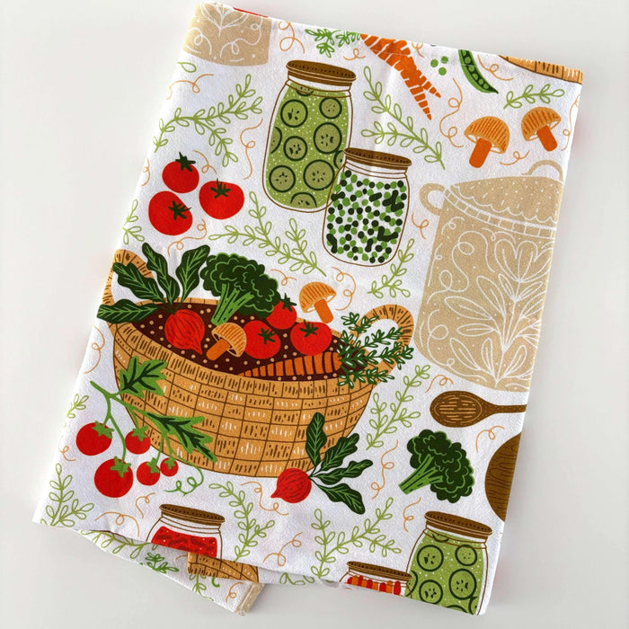Kitchen towel with vegetable and jar pattern on a white background