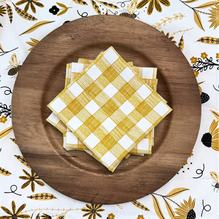 bundle of tabletop products - white table runner with bee and floral elements, gold gingham cloth napkins