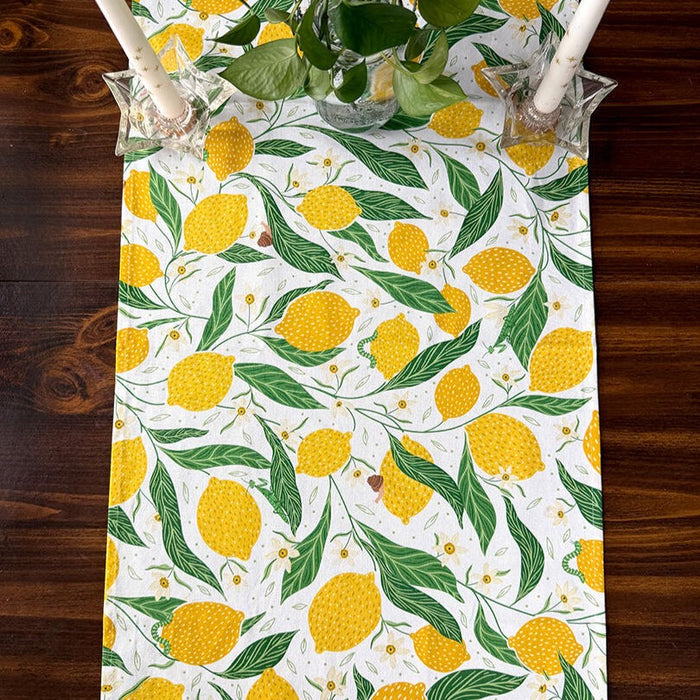 Table runner with lemon and leaf pattern on a wooden table