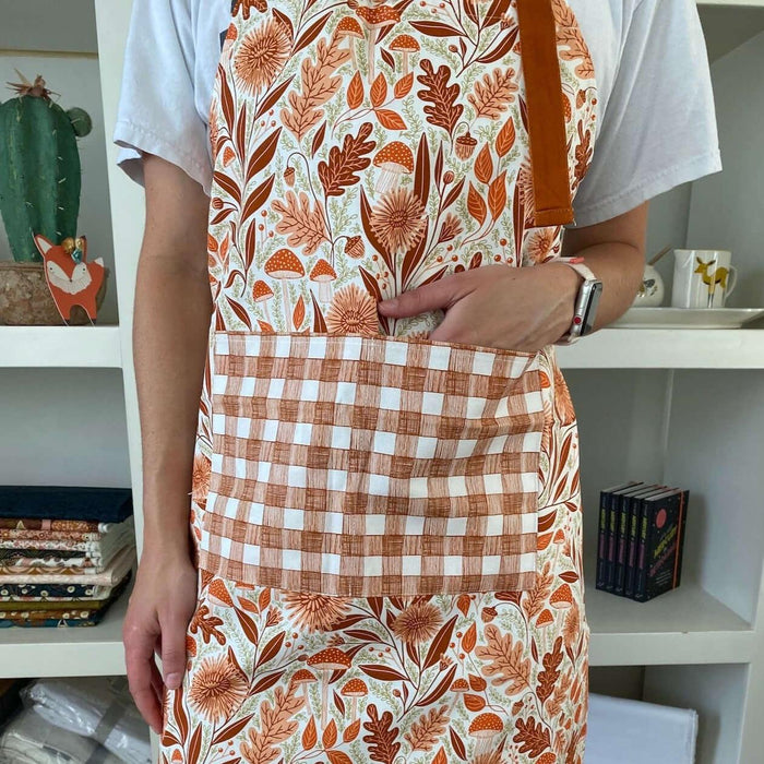 Mushroom Medley Apron—bake in style with gingiber apron featuring mushroom print, adjustable neck strap, large pocket, 100% cotton canvas