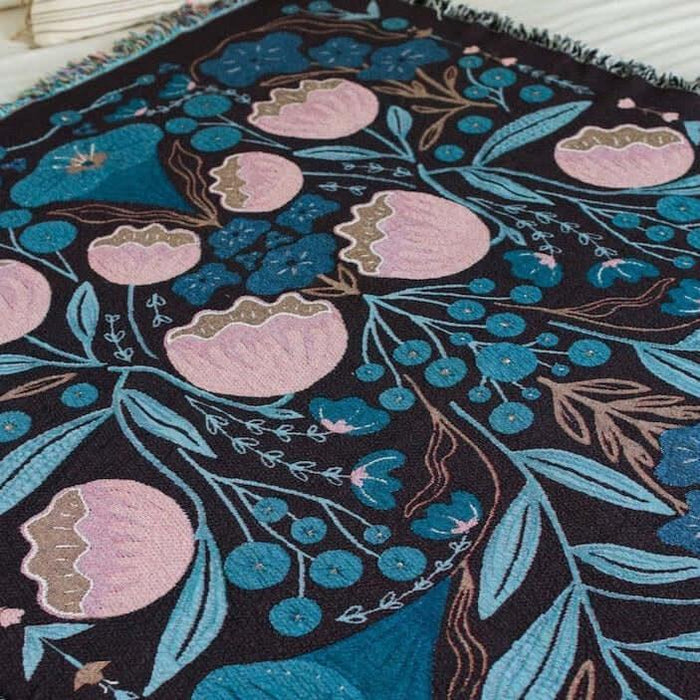 blanket with pink and dark blue floral designs
