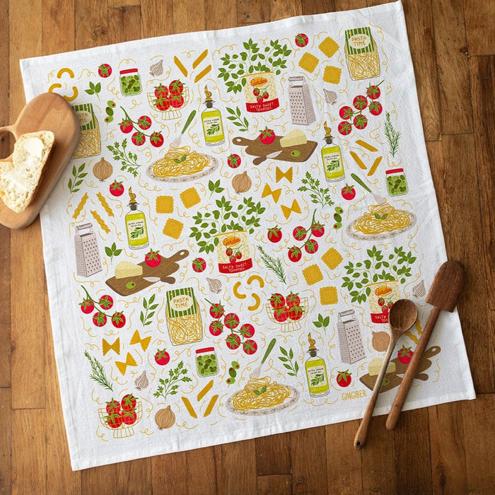 Decorative kitchen towel with food-themed illustrations on a wooden surface