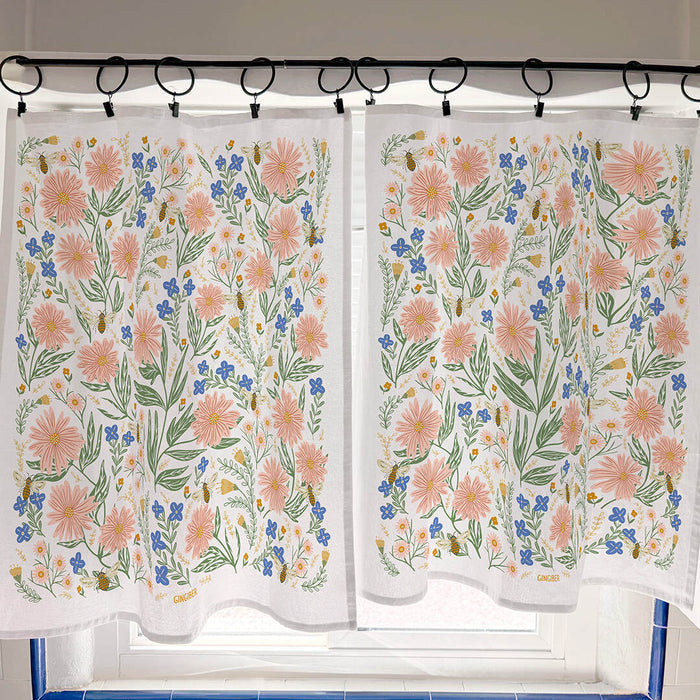 Floral patterned cafe curtain with pink flowers and green leaves on a white background.